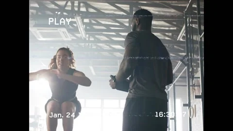 Trainer starting timer while trainee doing tuck jumps for power test, tapping Stock Footage 330392138