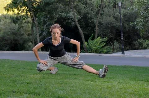 Trainer stretching in forest Stockfoto's