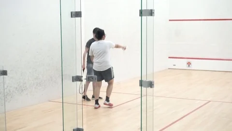 Trainer teaching how to play squash Stock Footage 121745153