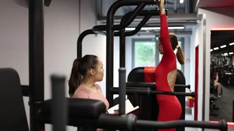 Trainer tracks client pull up progress Stock Footage 337114984