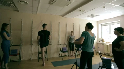 The trainer on yoga exercise shows students group Stock Footage 64808866
