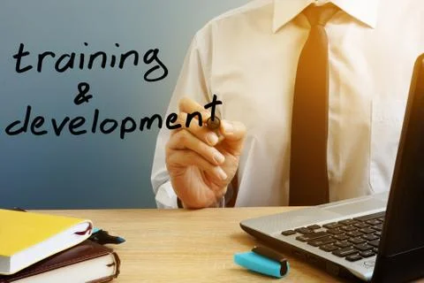 Training and development. Mentor with marker at the office table. Stock Photos