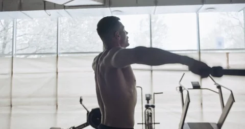 Training with barbell, intense strength exercise in closed gym. Men doing Stock Footage 130042584