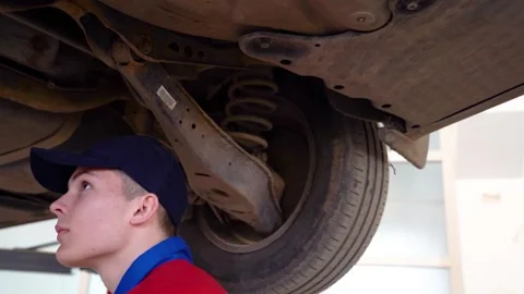 Training to become an auto mechanic at a technical college. Stock Footage 332920850