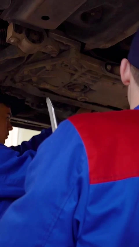 Training to become an auto mechanic at a technical college - Vertical Video Stock Footage 332979820