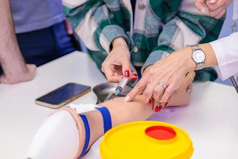 Training of blood sampling from a vein, on a model of a human hand. Stock Photos