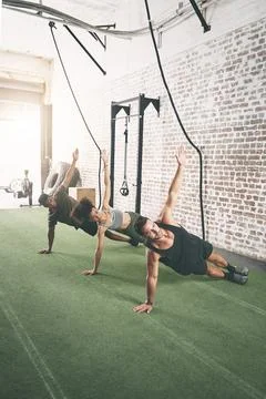 Training, class and side plank with people in gym for core workout, persona.. Stock Photos