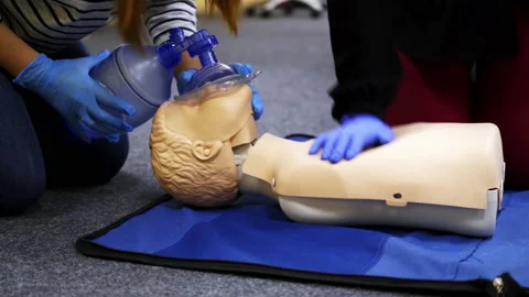 Training compression on a dummy. CPR exercise on a mannequin Stock Footage 146747050