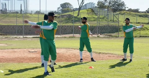 Training cone initiating diverse baseball players rotating arms forward and back Stock Footage 343512580