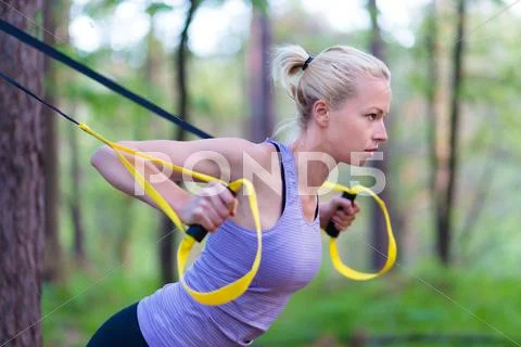 Training with fitness straps outdoors. Stock Photos