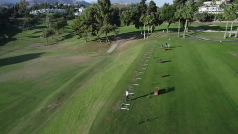 Training on the golf course. A man hits a ball Stock Footage 234447462