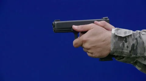 Training with a gun with blue screen background Stock Footage 64376649