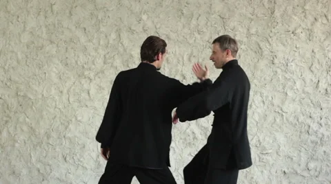 Training in the hall. Two men practicing the elements of tai chi 库存影片 64591395