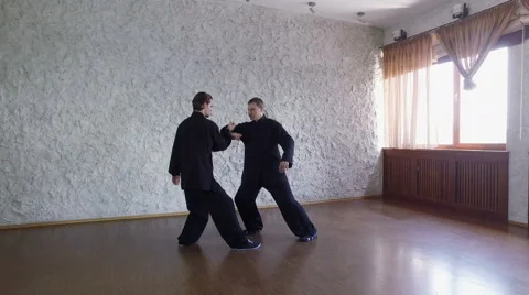 Training in the hall. Two men practicing the elements of tai chi. 4K Video stock 65366645