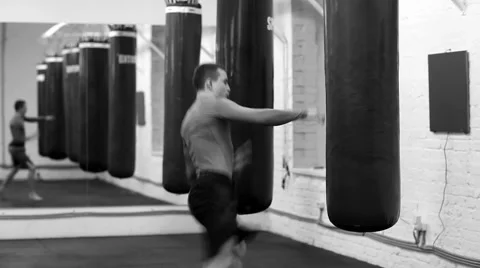 Training at his best. Young professional kick-boxer with a punching bag 스톡 동영상 58556431