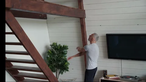 Training at home. Athletic and strong mature man doing pull ups exercises on Stock Footage 135739149