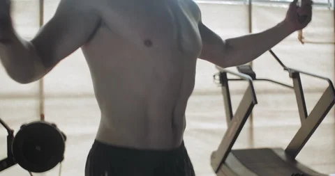 Training with jump rope, intense strength exercise in closed gym. Men doing Stock-Footage 129982402