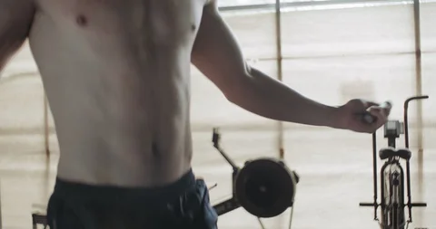 Training with jump rope, intense strength exercise in closed gym. Men doing Stock Footage 130015760