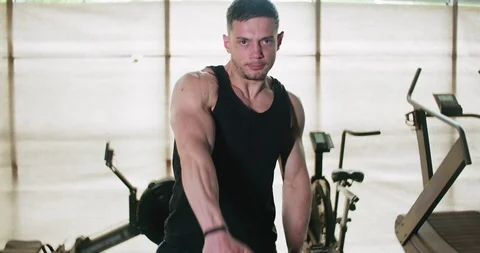 Training with kettlebells, intense strength exercise in closed gym. Men doing Stock-Footage 129978710