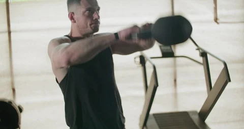 Training with kettlebells, intense strength exercise in closed gym. Men doing Stock-Footage 130014359