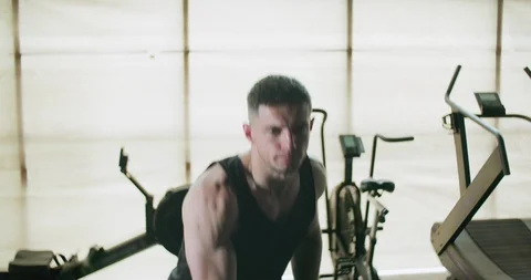 Training with kettlebells, intense strength exercise in closed gym. Men doing Stock Footage 130042262