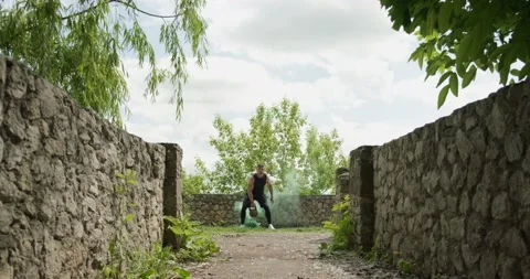 Training with kettlebells, intense strength exercise outdoor with smoke Stock Footage 132973850