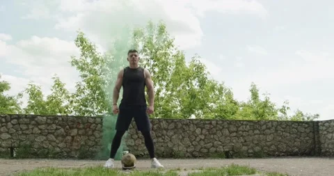 Training with kettlebells, intense strength exercise outdoor with smoke Stock Footage 132974501