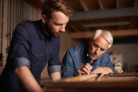 Training, learning and carpentry apprentice with man, teaching woodwork and Stock Photos