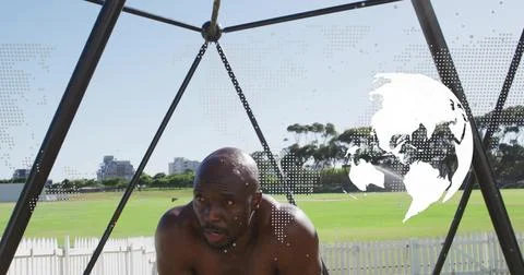 Training mature man exercising bare-chested in sports field, with triangular Fotos de archivo