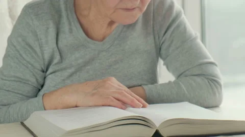 Training of memorization and memory of the elderly. elderly woman reads a book Stock Footage 123767795