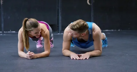 Training Pair Doing Plank Pose Stock Footage 75039276