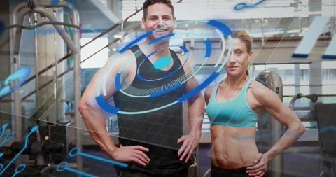 Training partners standing at gym cable machine upon graphics appearing and Stockbeeldmateriaal 317840876
