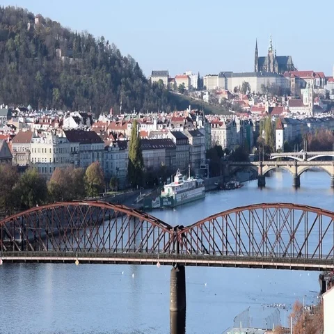 Training passing over bridge in Prague, overlooking Prague Castle Stock Footage