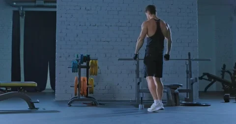 Training of a professional athlete, basic exercises with dumbbells. Muscular Video stock 132603984