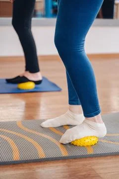 Training session with foot exercises using a fitness ball, focused leg workout. Stock Photos