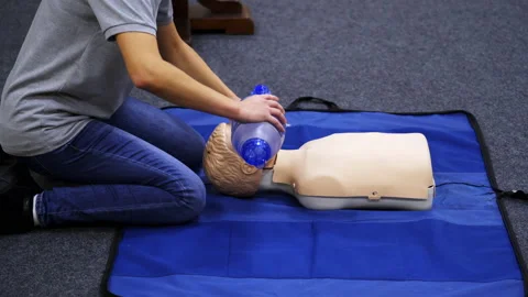 Training session for saving life. Instructor shows cardiac exercise  Stock Footage 146746461
