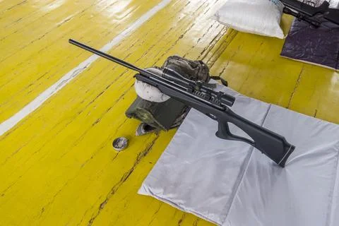 Training session for shooting practice on a bright yellow floor at an indoor Stock Photos