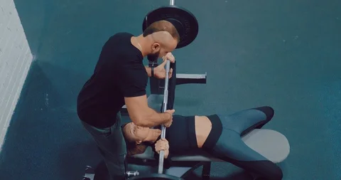 Training with a trainer, basic exercises with a barbell. Brutal trainer helps a 스톡 동영상 122705251