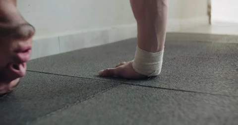 Training vertical push-ups, intense strength exercise in closed gym. Men doing Stock Footage 130014960