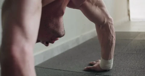 Training vertical push-ups, intense strength exercise in closed gym. Men doing Stock Footage 130042663