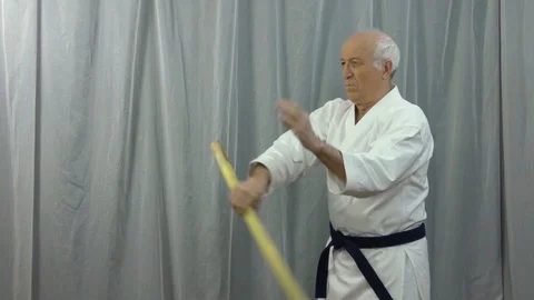 Training video of stick training performed by an old male athlete Stock Footage 129774816