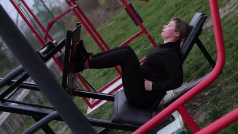 Training in the yard on simulators. The girl is losing weight Stock Footage 270432401