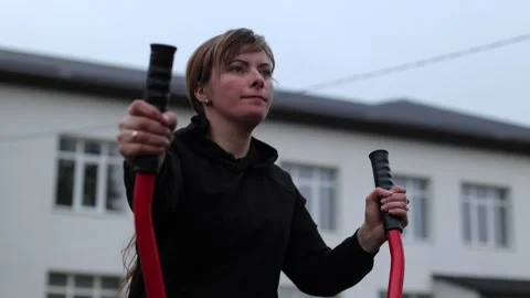 Training in the yard on simulators. The girl is losing weight Stock Footage 270432443