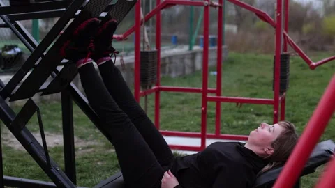Training in the yard on simulators. The girl is losing weight Stock Footage 270432456
