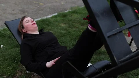 Training in the yard on simulators. The girl is losing weight Stock Footage 270432490