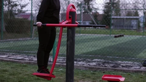 Training in the yard on simulators. The girl is losing weight Stock Footage 270432691