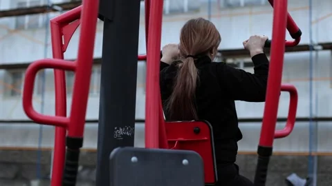 Training in the yard on simulators. The girl is losing weight Stock Footage 270432694