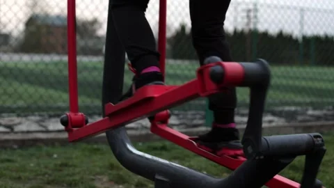 Training in the yard on simulators. The girl is losing weight Stock Footage 270433148