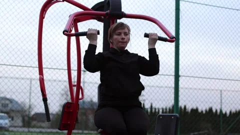Training in the yard on simulators. The girl is losing weight Stock Footage 270433343