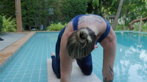 By training in yoga and relaxation techniques outdoors, this person enjoys a Stock Footage 240080398